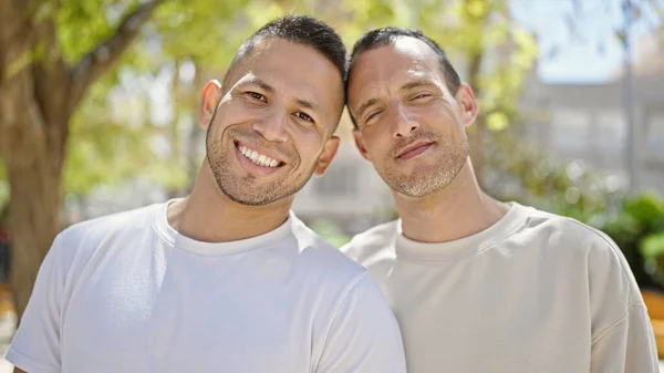 stock image Two men couple smiling confident standing together at park