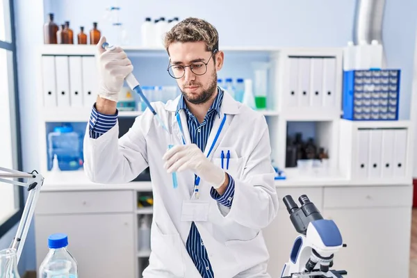 Junger Mann Schüttet Labor Flüssigkeit Auf Reagenzglas — Stockfoto