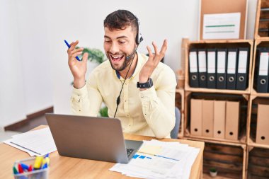 Young hispanic man call center agent having video call at office