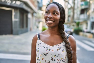 African american woman smiling confident looking to the side at street