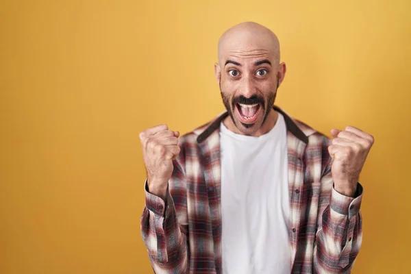 Hispanic Man Beard Standing Yellow Background Celebrating Surprised Amazed Success —  Fotos de Stock