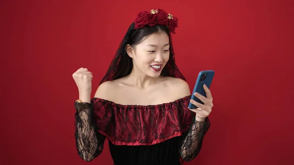 Young Chinese Woman Wearing Katrina Costume Using Smartphone Isolated Red — Foto de Stock