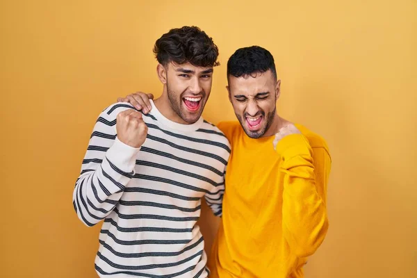 Young Hispanic Gay Couple Standing Yellow Background Very Happy Excited — Stock Photo, Image