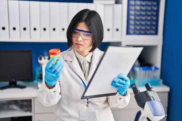 Young Chinese Woman Scientist Analysing Urine Reading Report Document Laboratory — Stock Photo, Image