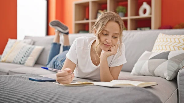 Young Blonde Woman Reading Book Writing Notebook Home — Stock Photo, Image