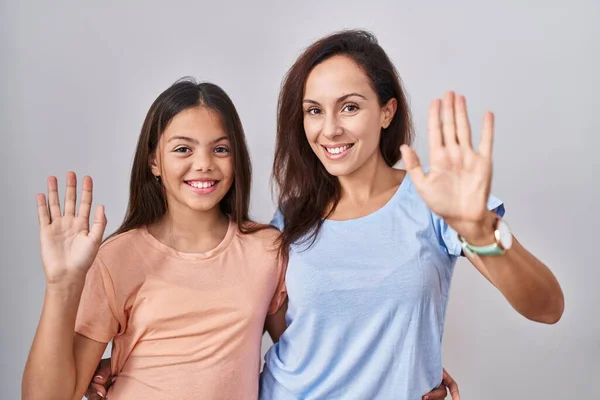 Young Mother Daughter Standing White Background Waiving Saying Hello Happy — Stock Photo, Image