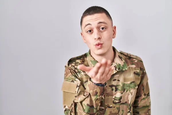 Ung Man Klädd Kamouflage Armé Uniform Tittar Kameran Blåser Kyss — Stockfoto