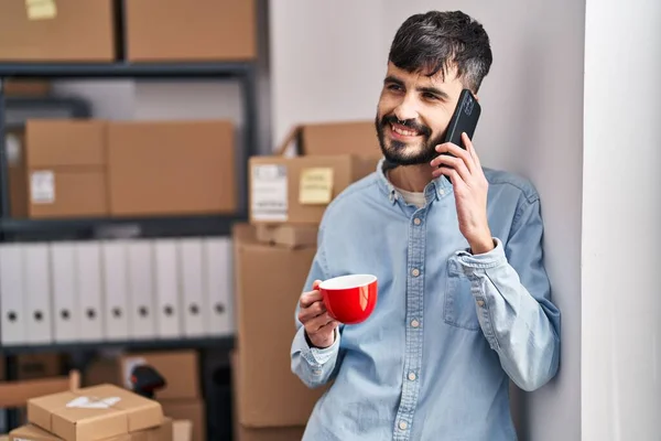 Young Hispanic Man Ecommerce Business Worker Talking Smartphone Drinking Coffee — Stockfoto