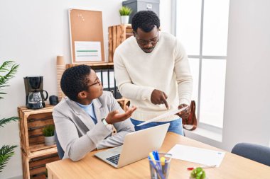 Man and woman business workers using laptop working at office