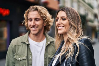 Man and woman couple smiling confident standing together at street