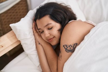 Young woman lying on bed sleeping at bedroom