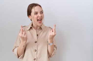 Young caucasian woman wearing casual shirt showing middle finger doing fuck you bad expression, provocation and rude attitude. screaming excited 