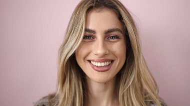 Young blonde woman smiling confident standing over isolated pink background