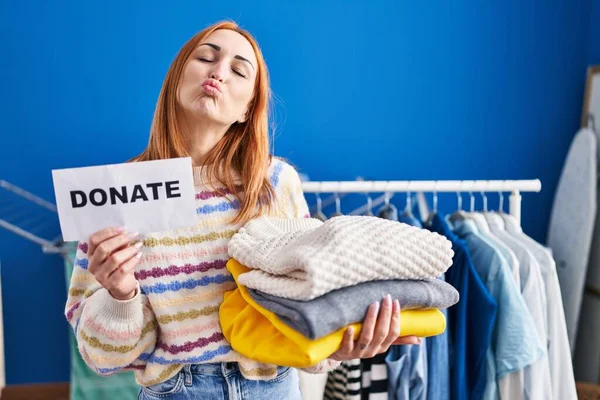 stock image Young woman holding donations for charity looking at the camera blowing a kiss being lovely and sexy. love expression. 