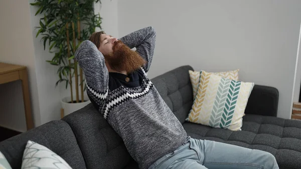 Young Redhead Man Relaxed Hands Head Sitting Sofa Home — Stockfoto
