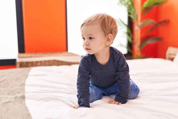 Adorable Blond Toddler Sitting Bed Relaxed Expression Bedroom — Stock Photo, Image