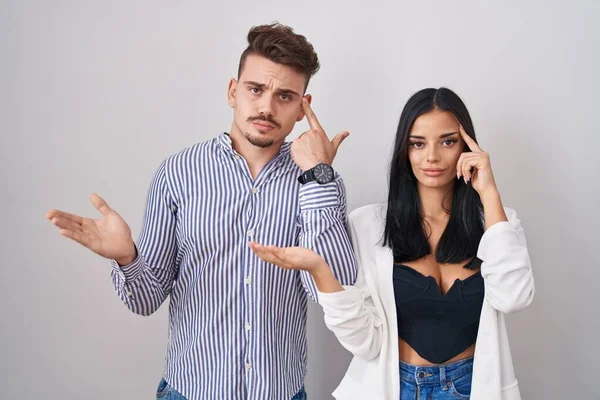 Young Hispanic Couple Standing White Background Confused Annoyed Open Palm — Stock Photo, Image