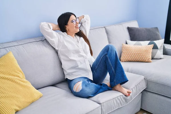 Young Hispanic Woman Relaxed Hands Head Sitting Sofa Home — Foto de Stock