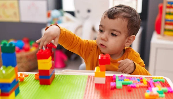 Adorable Hispanic Boy Playing Construction Blocks Sitting Table Kindergarten — Stockfoto
