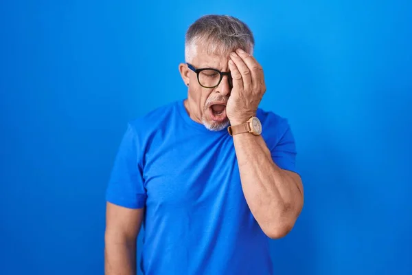 Hispanic Man Grey Hair Standing Blue Background Yawning Tired Covering — Stock Photo, Image
