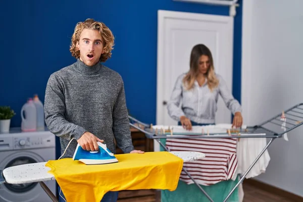 Couple Ironing Clothes Laundry Room Scared Amazed Open Mouth Surprise — Fotografia de Stock