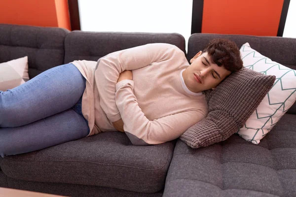 Non Binary Man Suffering Stomach Ache Lying Sofa Home — Stock Fotó