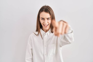 Young caucasian woman standing over isolated background pointing displeased and frustrated to the camera, angry and furious with you 