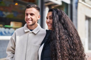 Man and woman couple smiling confident standing together at street