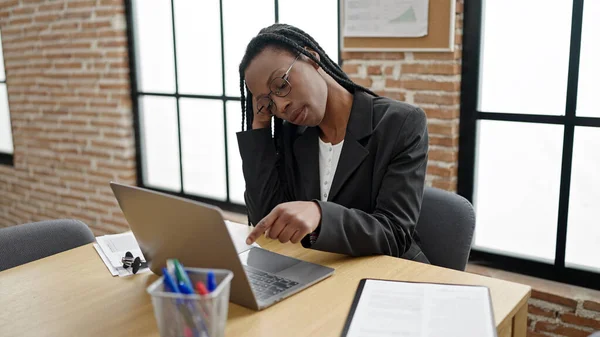 アフリカ系アメリカ人女性のビジネスマンがオフィスでノートパソコンを使って退屈 — ストック写真