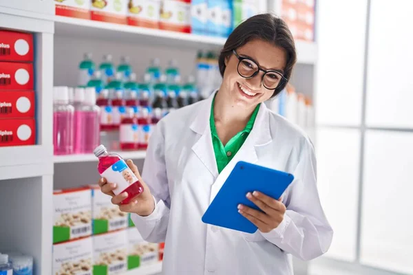 Young Hispanic Woman Pharmacist Using Touchpad Holding Medicine Bottle Pharmacy — ストック写真