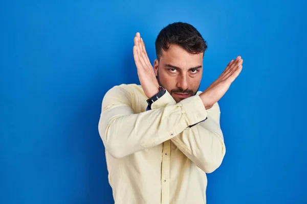 Handsome Hispanic Man Standing Blue Background Rejection Expression Crossing Arms — Stock Photo, Image