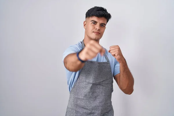 Hispanic Young Man Wearing Apron White Background Punching Fist Fight — Stock Photo, Image