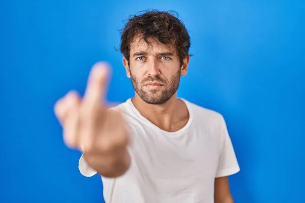 Hispanic Young Man Standing Blue Background Showing Middle Finger Impolite — стоковое фото