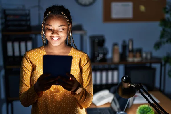 Αφροαμερικανή Γυναίκα Κοτσίδες Που Δουλεύει Στο Γραφείο Νύχτα Τάμπλετ Χαρούμενο — Φωτογραφία Αρχείου