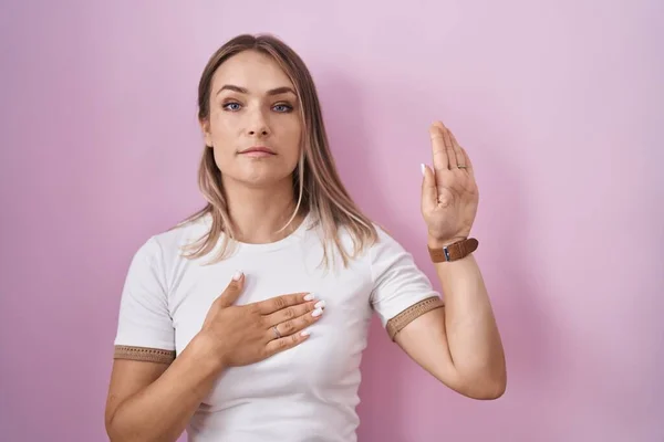 Blonde Caucasian Woman Standing Pink Background Swearing Hand Chest Open — 图库照片
