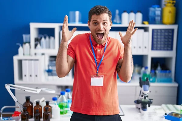 Young Hispanic Man Working Scientist Laboratory Celebrating Crazy Amazed Success — Stock Photo, Image