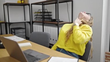 Young blonde woman business worker tired working at office