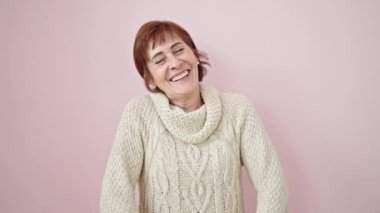 Soyutlanmış pembe arka planda kendine güvenen olgun İspanyol kadın.