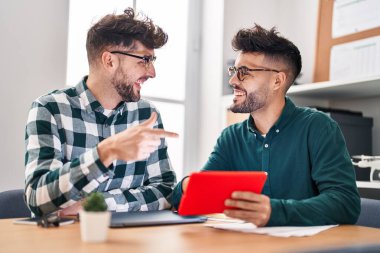 Young couple business workers using touchpad working at office