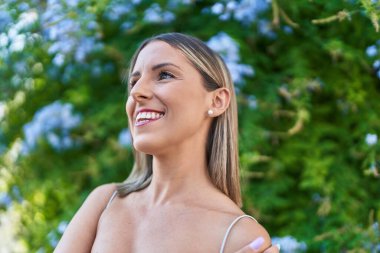 Young beautiful hispanic woman smiling confident looking to the sky at park