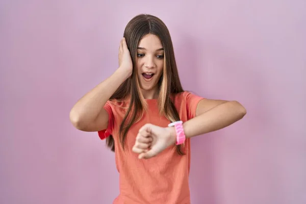 Teenager Girl Standing Pink Background Looking Watch Time Worried Afraid — Stock Photo, Image