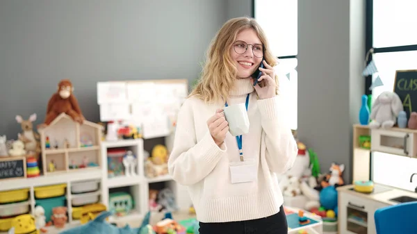 Young Blonde Woman Preschool Teacher Talking Smartphone Drinking Coffee Kindergarten — Foto de Stock