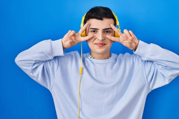 Non Binary Person Listening Music Using Headphones Doing Peace Symbol — Photo