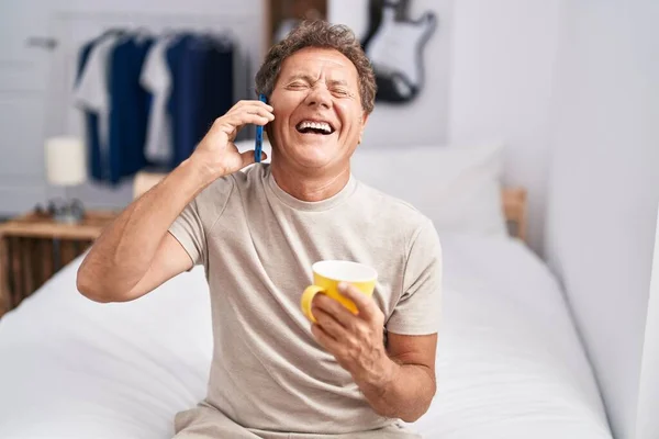 Middle Age Man Talking Smartphone Drinking Coffee Bedroom — Stockfoto