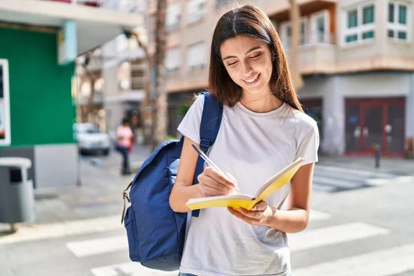 Young Beautiful Hispanic Woman Student Smiling Confident Writing Notebook Street — ストック写真