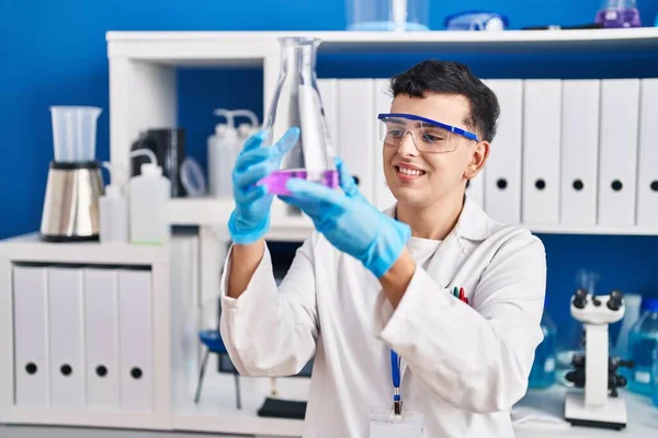 Young Non Binary Man Scientist Smiling Confident Measuring Liquid Laboratory — Stock fotografie
