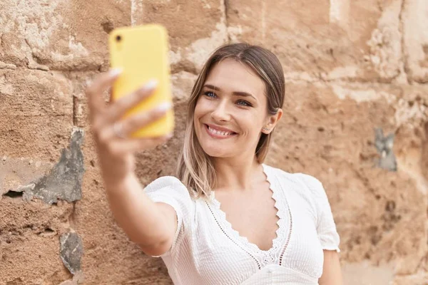 Young Caucasian Woman Smiling Confident Making Selfie Smartphone Isolated Brick — Foto de Stock