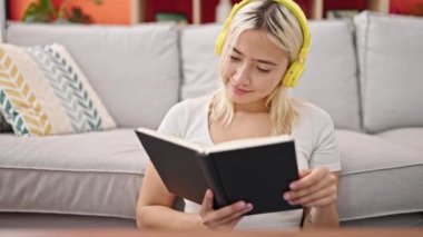 Genç, güzel, İspanyol bir kadın kitap okuyor. Evde müzik dinliyor.