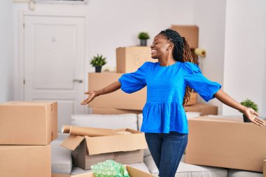 Yeni evinde kendine güvenen Afrikalı Amerikalı kadın gülümsüyor