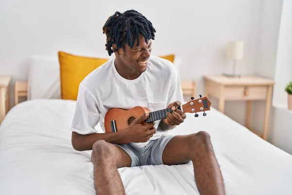 African American Man Playing Ukelele Sitting Bed Bedroom — 图库照片